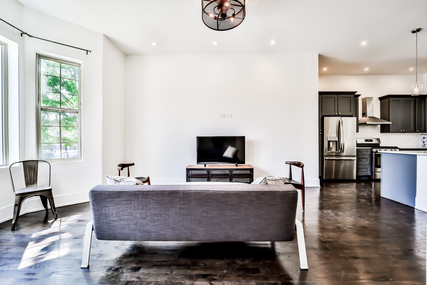 Renovated living room and kitchen in a South Side home managed by Good Karma Estates